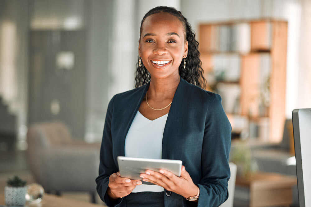 Firm card - smiling businesswoman in her law office with a tablet